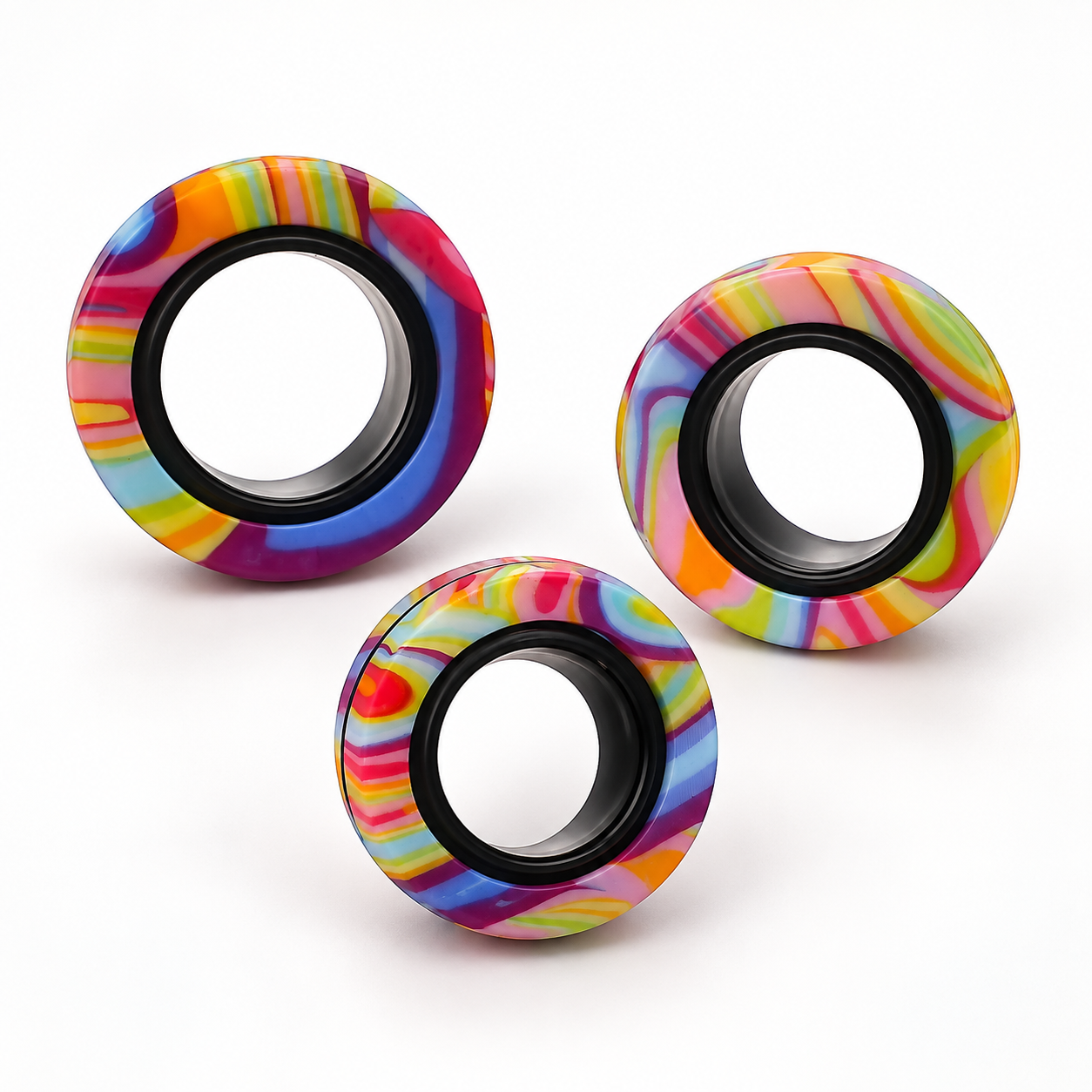 Three colourful magnetic ring spinners on a clean white background